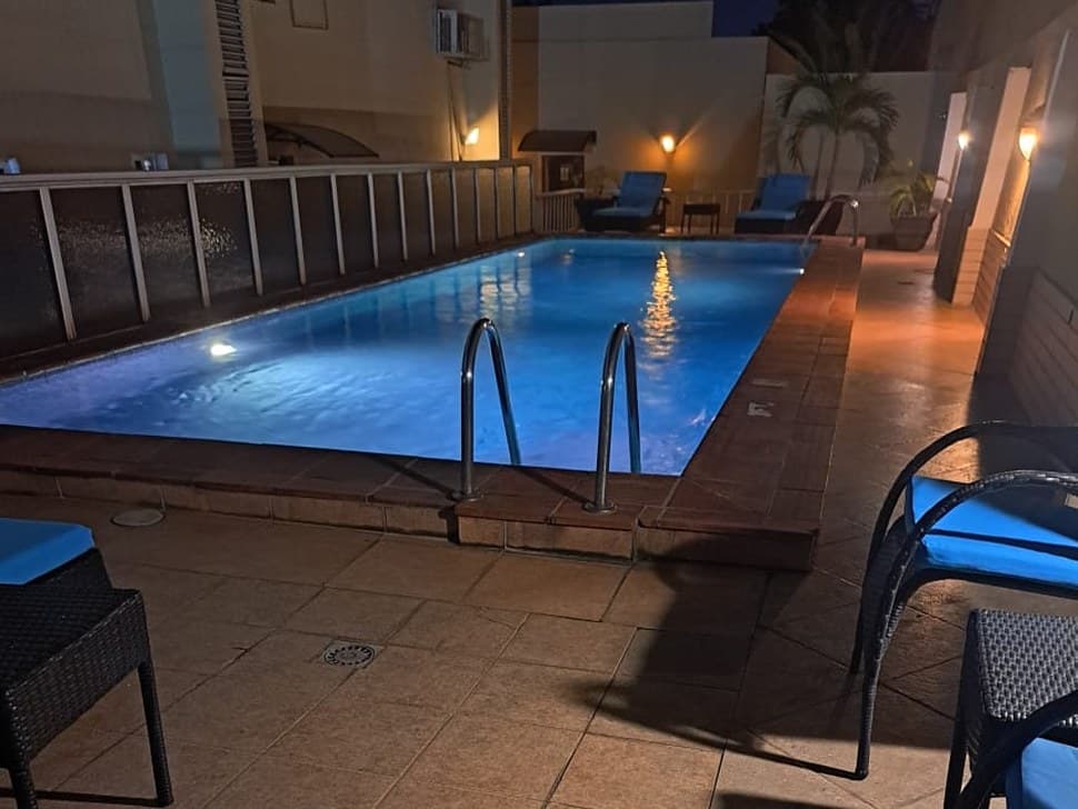 The Savoy Summerset pool lit up in the evening